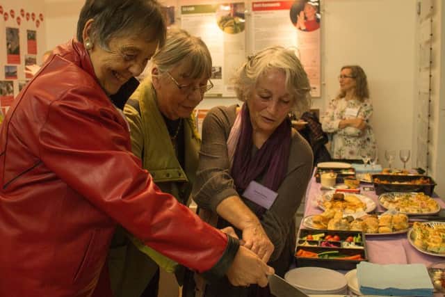 Jane Henshaw, Liz Leyh and Deirdre Battista cut the celebratory cake. Picture: Liz Whitelegg.