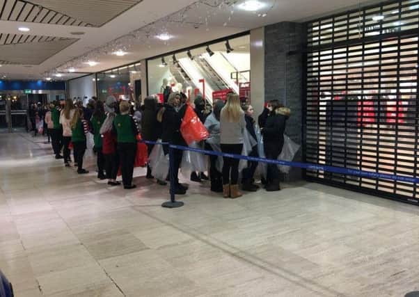 Queues building up at Next in centre:mk