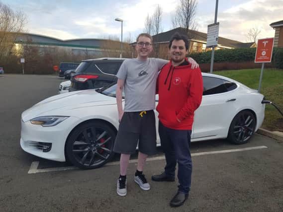 Chris Holt, left, is desperate to achieve a life goal of owning a Tesla before he dies