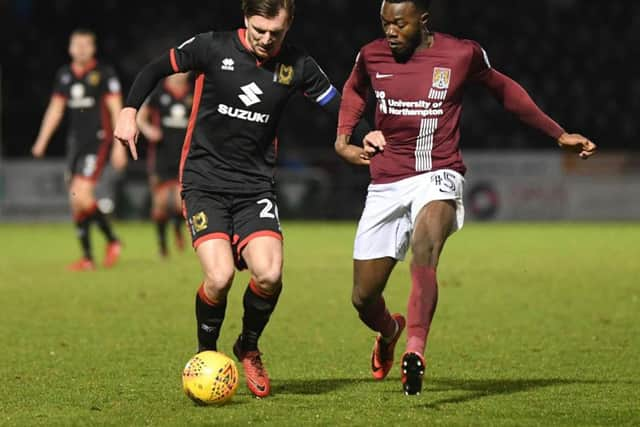 Alex Gilbey battles with Northampton's Gboly Ariyibi