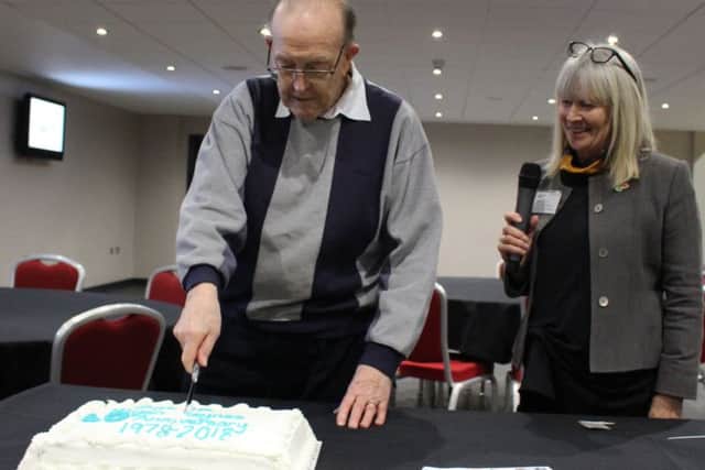 Cutting the cake at Age UK Milton Keynes 40th anniversary