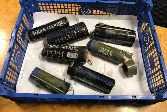 Used smoke grenades collected after the game against Portsmouth