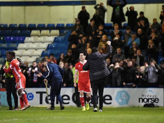 Dan Micciche celebrates with the MK Dons fans at Gillingham