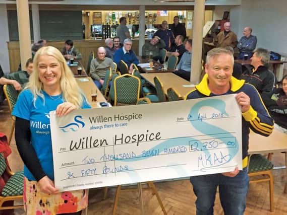 Willen Hospice's Lynette receiving 2,750 from MKAA's Dean Warren  proceeds of last year's Furzton festival