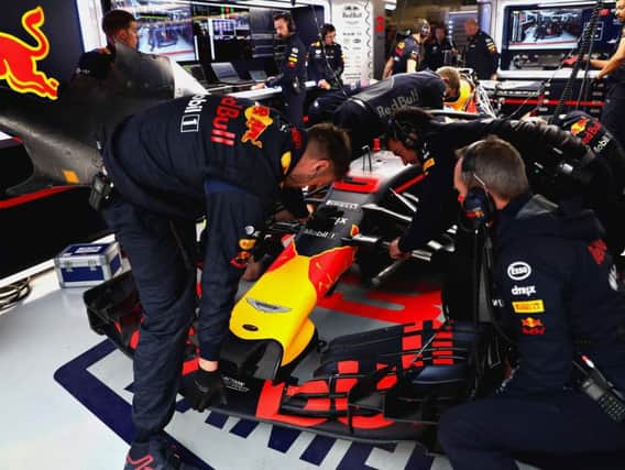 Red Bull mechanics work on Ricciardo's car