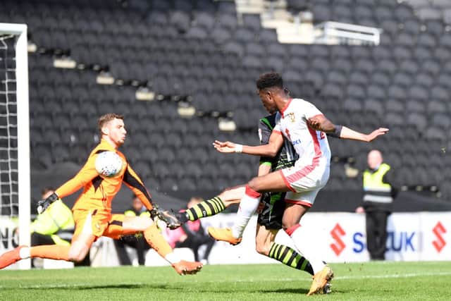 Ike Ugbo scores the opener for MK Dons