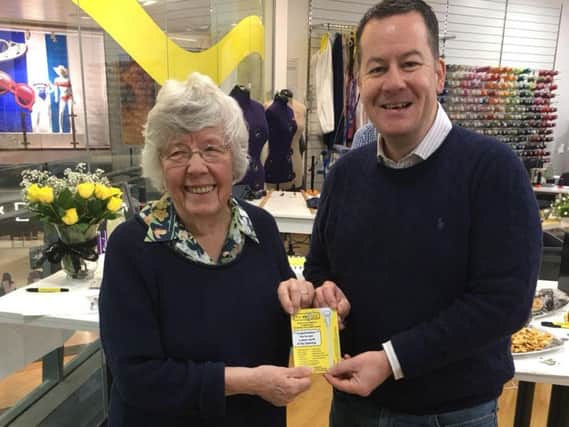 Dry cleaning made easy - Mary takes receipt of her winning ticket