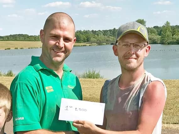 TACKLE Hub feeder fest winner Dave Bagley (left) collecting from Neil Richardson