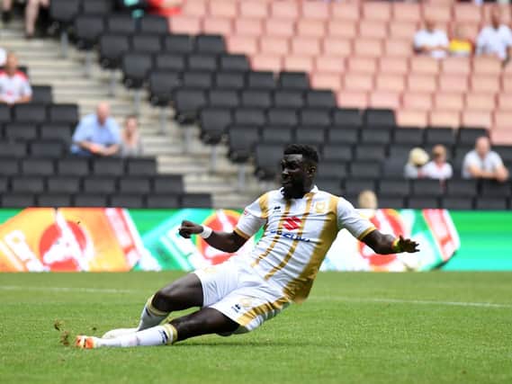 Ouss Cisse slides in George Williams' cross to win it for MK Dons