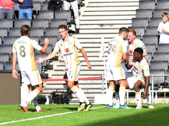 MK Dons celebrate Kieran Agard's goal from the penalty spot