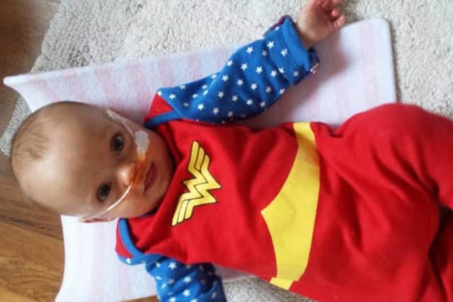 Phobe in a Wonder Woman costume as a baby
