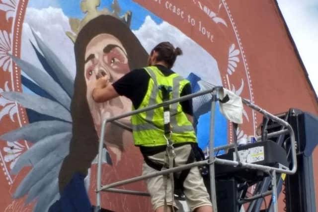Luke at work on the mural