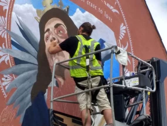 Luke at work on the mural