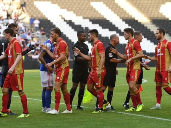 MK Dons wore red at home to Ipswich in the summer