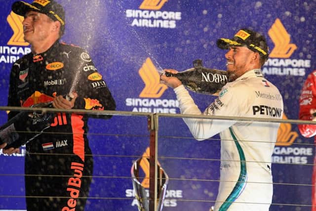 Max Verstappen celebrates on the podium with race winner Lewis Hamilton
