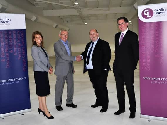 Richard Millard, Paula Stuart and Darren Millis of Geoffrey Leaver Solicitors are shown around the new galleries by Museum Director Bill Griffiths