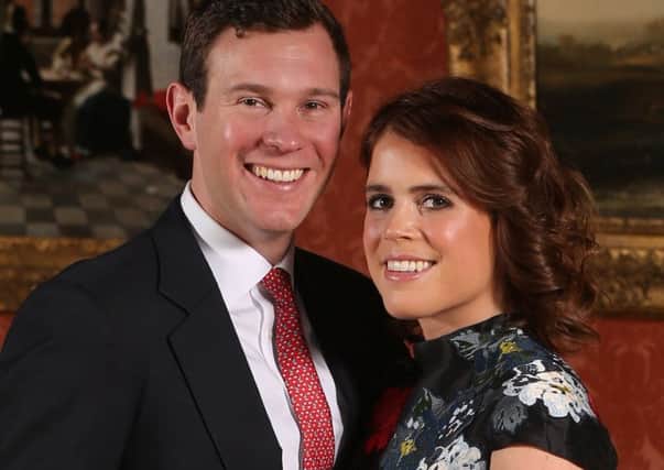 ALTERNATE CROP
Princess Eugenie and Jack Brooksbank in the Picture Gallery at Buckingham Palace in London after they announced their engagement. Princess Eugenie wears a dress by Erdem, shoes by Jimmy Choo and a ring containing a padparadscha sapphire surrounded by diamonds. PRESS ASSOCIATION Photo. Picture date: Monday January 22, 2018. They are to marry at St GeorgeÃs Chapel in Windsor Castle in the autumn this year. See PA story ROYAL Eugenie. Photo credit should read: Jonathan Brady/PA Wire PPP-180123-095819001