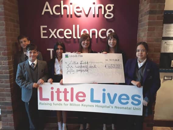 Students from the school presenting the cheque to Milton Keynes Hospital Charity