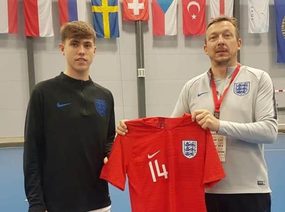 Rhyan is pictured with England staff member Mike Nolan, being handed his England jersey