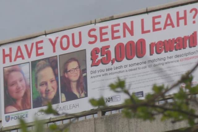 A banner offering a 5,000 reward to help find Leah