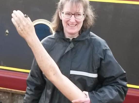 A member of the clean-up crew with the arm found in the canal