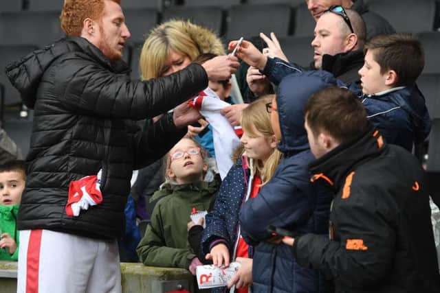 Dean Lewington signs autographs for MK Dons fans