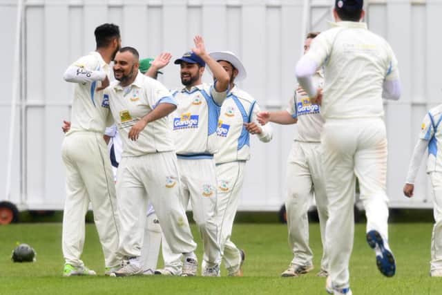 Wolverton celebrate the wicket of Bertie Barrett