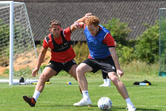 Houghton battles with Dean Lewington in training