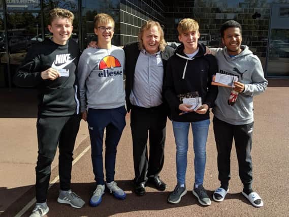 Fans pose with Dons chairman Pete Winkelman after buying their Liverpool tickets