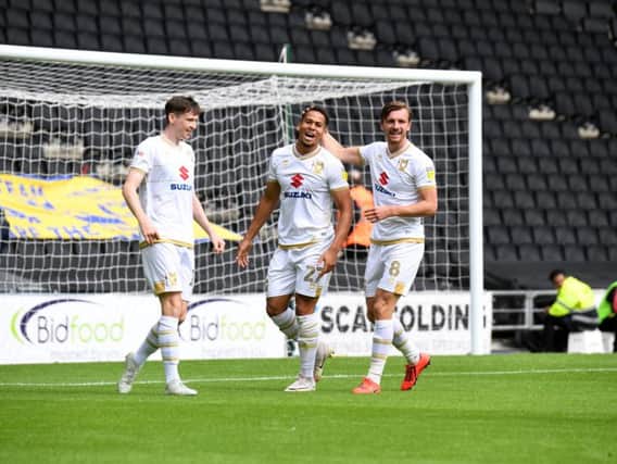 Sam Nombe celebrates with Alex Gilbey and Conor McGrandles