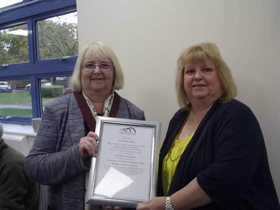 Kevin's wife pictured accepting the award from Cllr Sue Smith, leader of Woughton Community Council
