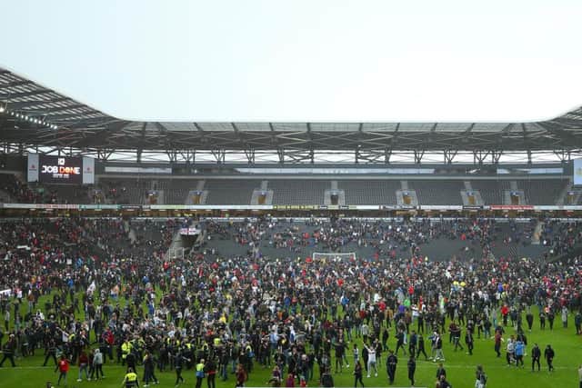 Fans on the pitch at Stadium MK
