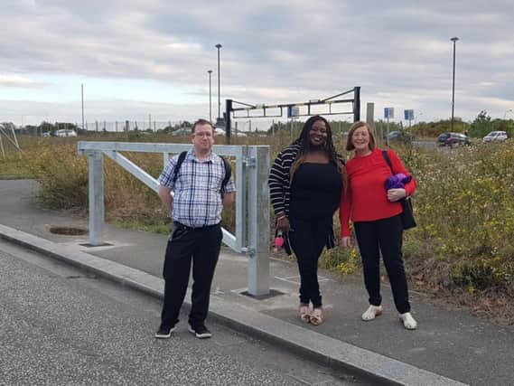 Councillors Paul Williams, left, with CMK ward colleagues Moriah Priestley, and Pauline Wallis, at a car park barrier installed to help stop car cruising.