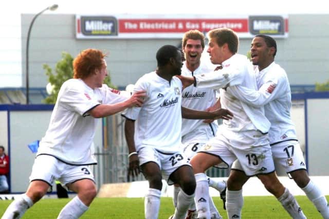 Dons celebrate Edds' winner which would keep them in League One