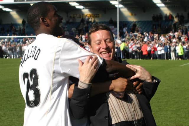 Izale McLeod celebrates staying up with manager Danny Wilson