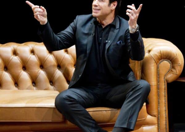 John Travolta in conversation. Photo supplied by WENN.