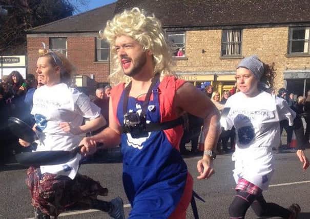 Blue Peter presenter Barney Harwood takes part in Olney's Pancake Day race. Picture by TristanHay Interiors