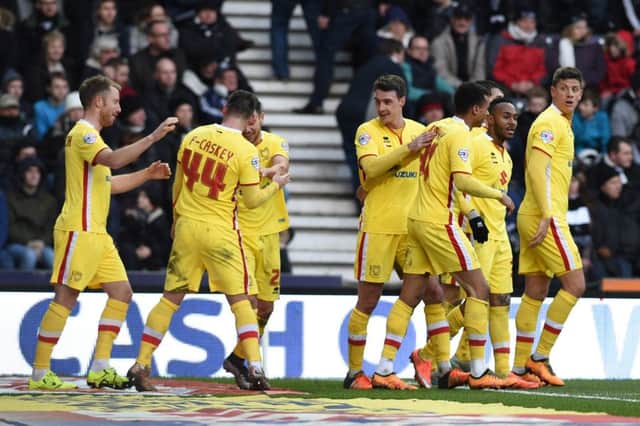 MK Dons players celebrate their second half gol during the Sky Bet Championship match between Derby County and Milton Keynes Dons at the iPro Stadium, Derby, England on 13 February 2016. Photo by Jon Hobley. PNL-160213-175815002
