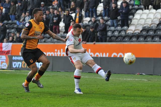 Milton Keynes Dons midfielder Antony Kay(6) clears the  ball away from Hull City striker Abel Hernandez (9) during the Sky Bet Championship match between Hull City and Milton Keynes Dons at the KC Stadium, Kingston upon Hull, England on 12 March 2016. Photo by Ian Lyall. PNL-161203-171627002