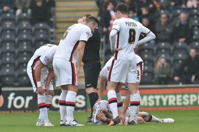 Milton Keynes Dons defender Kyle McFadzean(5) sustains an injury during the Sky Bet Championship match between Hull City and Milton Keynes Dons at the KC Stadium, Kingston upon Hull, England on 12 March 2016. Photo by Ian Lyall. PSI-1701-0024