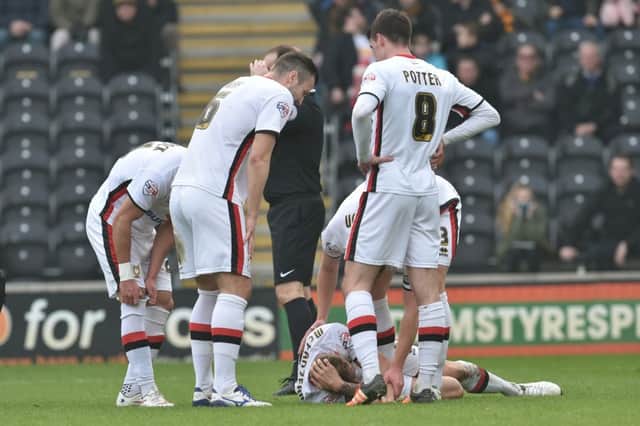 Milton Keynes Dons defender Kyle McFadzean(5) sustains an injury  during the Sky Bet Championship match between Hull City and Milton Keynes Dons at the KC Stadium, Kingston upon Hull, England on 12 March 2016. Photo by Ian Lyall. PSI-1701-0024