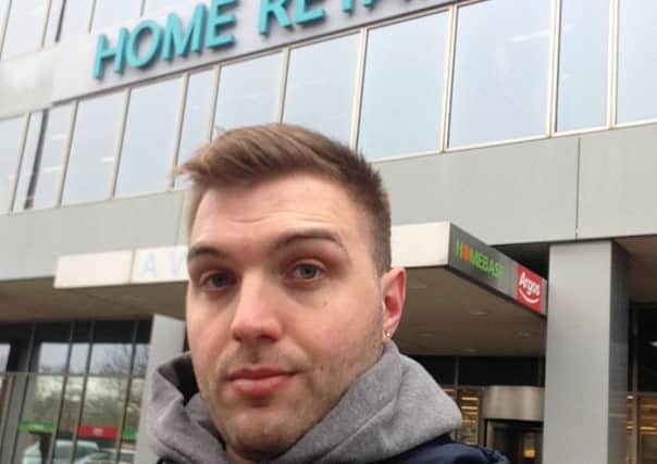 Demanding Dean Bland is protesting outisde Home Retail Group's headquarters in MK after his washing machine caught fire