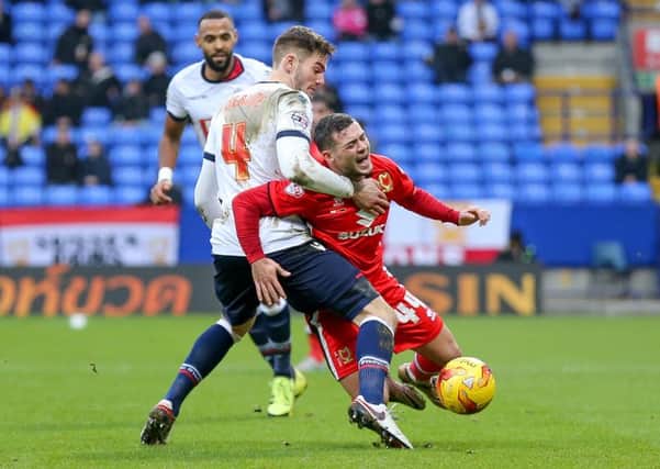 Bolton Wanderers defender Dorian Dervite  fouls MK Dons midfielder, on loan from Brighton & Hove Albion, Jake Forster-Caskey  during the Sky Bet Championship match between Bolton Wanderers and Milton Keynes Dons at the Macron Stadium, Bolton, England on 23 January 2016. Photo by Simon Davies. PSI-1453-0077