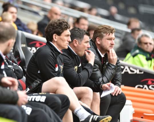Karl Robinson on the bench against Rotherham