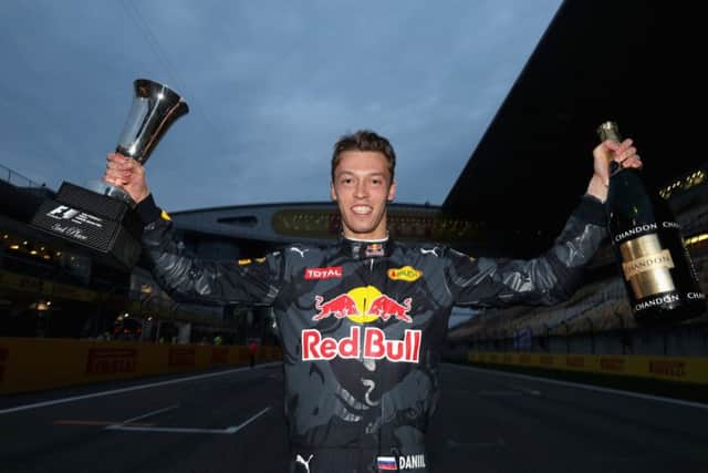 Daniil Kvyat celebrates with his Chinese Grand Prix trophy