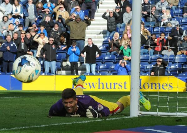 Alex Revell saves Joe Garner's penalty