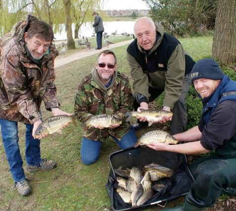 MKAA's Phil Oxley, Gary Maton and Mike Reveler, with 'Supa Carp' supplier Lee and a small sample of the fish which went into Furzton, Monday.