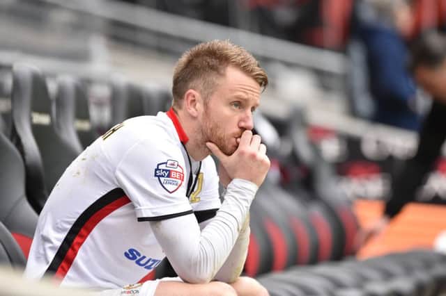 Dean Bowditch looks downbeat on the bench after Rotherham defeat