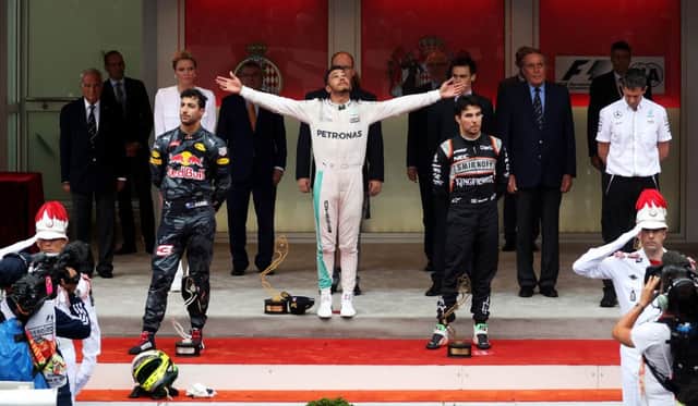 Lewis Hamilton celebrates on the podium in Monaco with a dejected Daniel Ricciardo