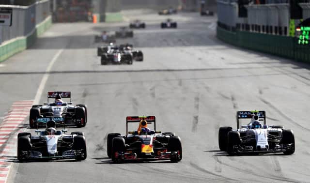 Max Verstappen, centre, battles with Valtteri Bottas (right) and Lewis Hamilton (left) in the European Grand Prix